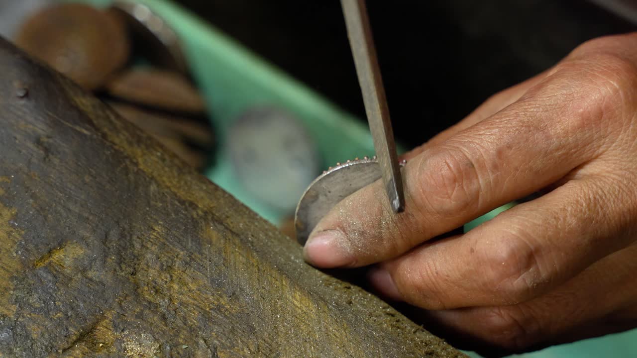 Silversmith crafts intricate silver in Celuk Village, Bali, with focus and care