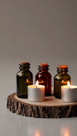 relaxing candles and essential oils on wooden tray