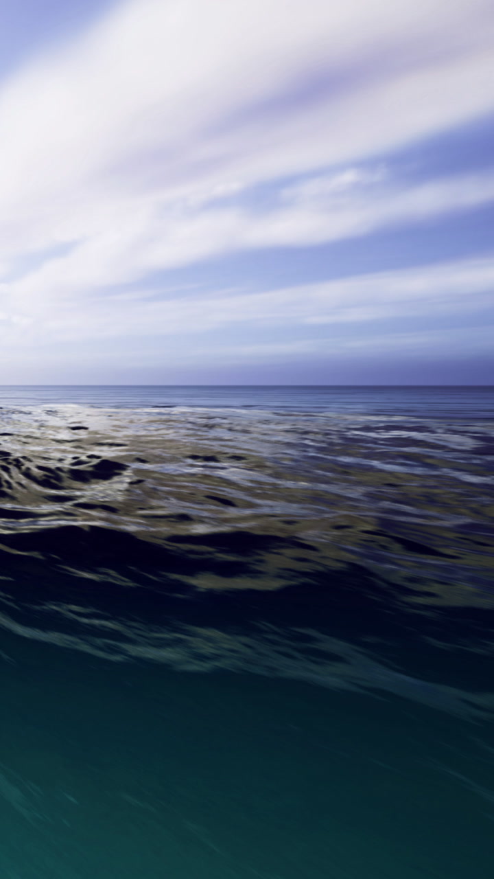 Waves dance gracefully under a bright sky at the tranquil ocean shoreline
