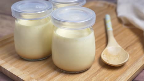 caramel pudding in a glass jar on table