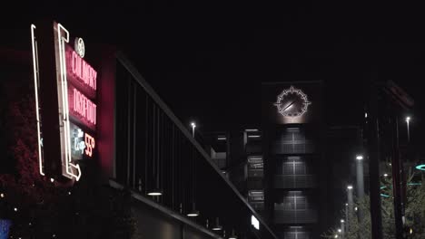 clock tower and neon sign in downtown