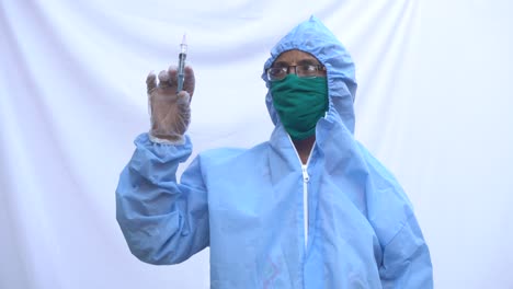 doctor in ppe kit blue protective suit, surgical mask latex gloves