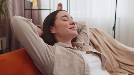 tired lazy woman enjoy relaxing on home sofa resting napping after hard working day closed her eyes