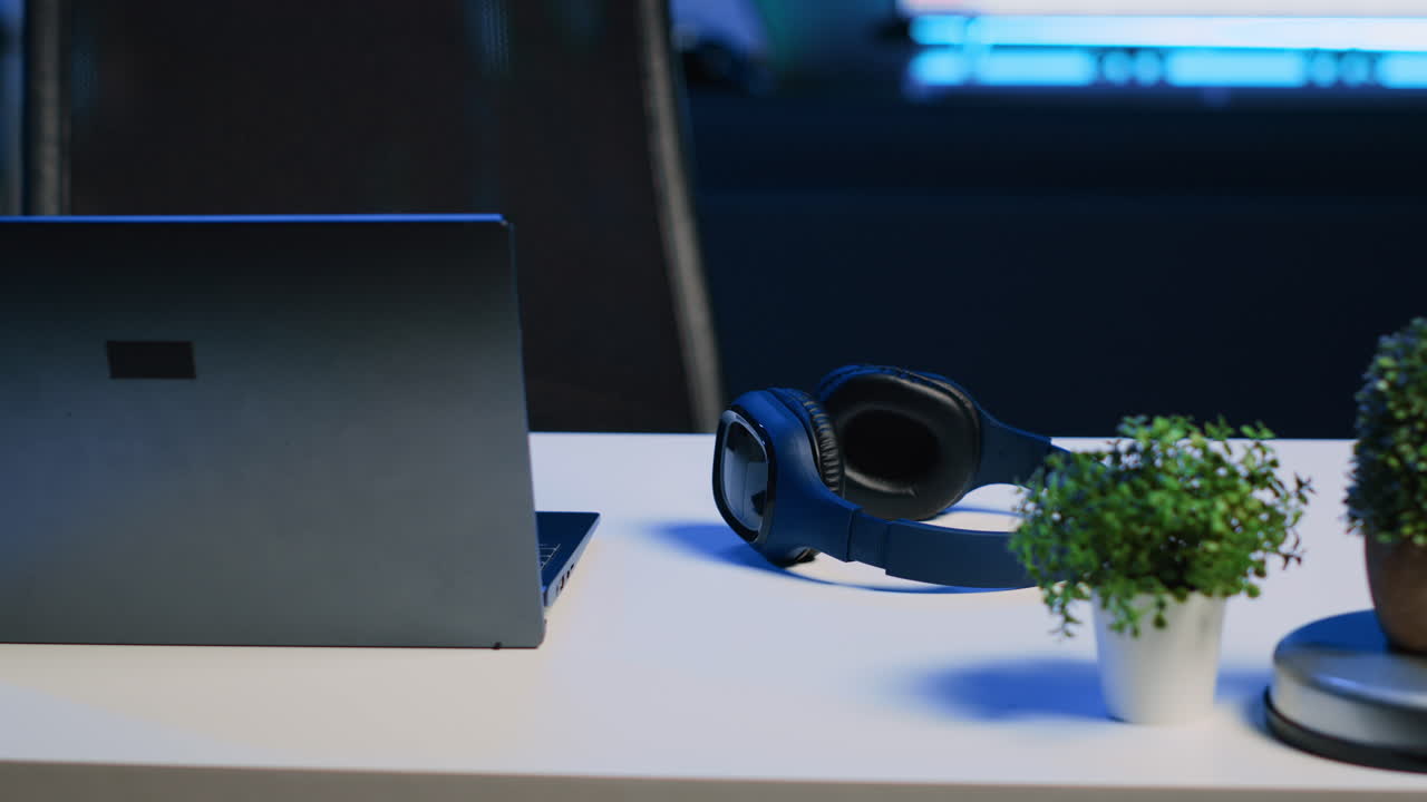 portátil, auriculares y mini plantas de la casa en la mesa en la habitación del apartamento
