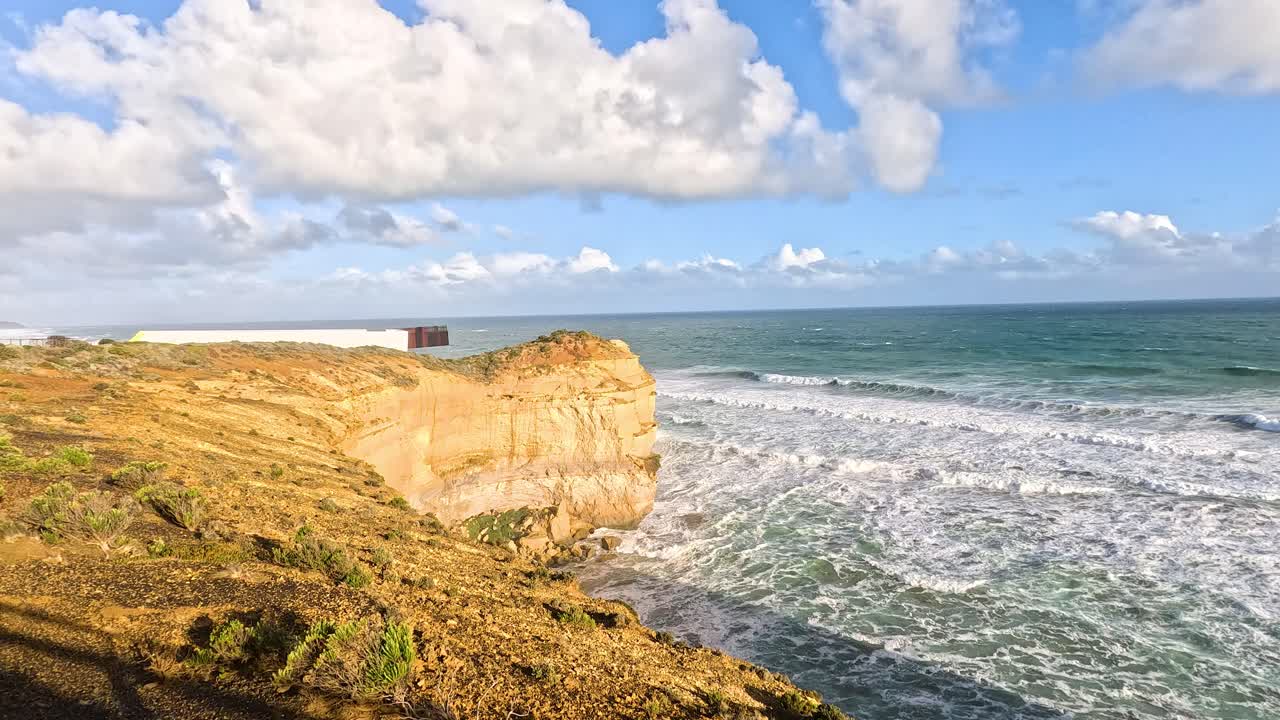 Waves crashing against iconic limestone cliffs