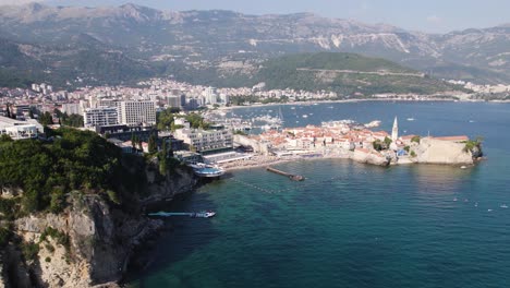 Aerial-view-of-coast-and-mountain-range,-medieval-walled-city-in-Budva,-Montenegro