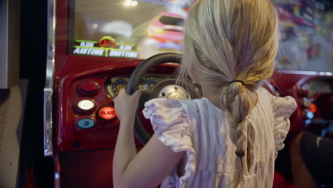 girl playing racing arcade game