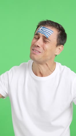 man cheering for greece during a match that is lost