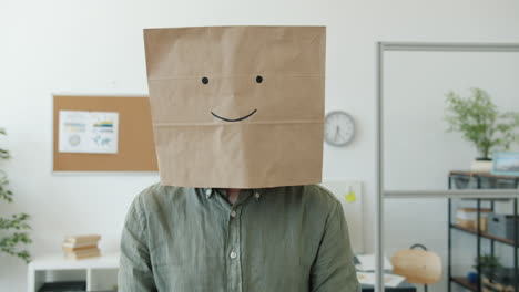 person with paper bag over head