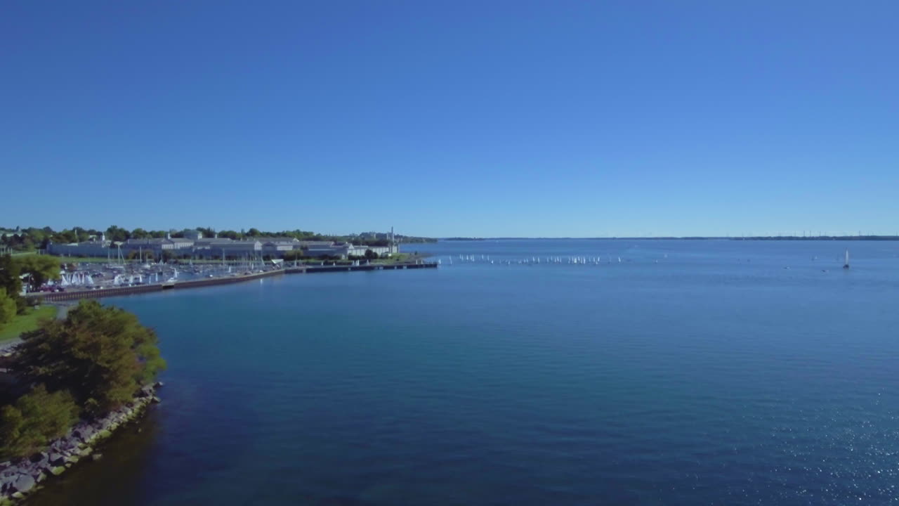 Helicopter flight over the ocean. Beautiful aerial view : Flying over a tree, descovering blue sea.