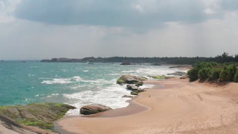 Ocean-Waves-crushing-sandy-and-rocky-coast-of-Sri-Lanka,-Awesome-Top-Drone-view