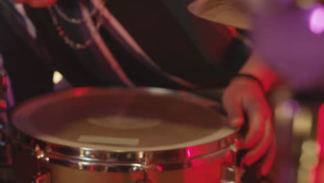 unrecognizable male musician adjusting his drum in recording studio