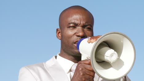 successful businessman giving briefings via megaphone