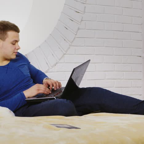 young man casually using a laptop