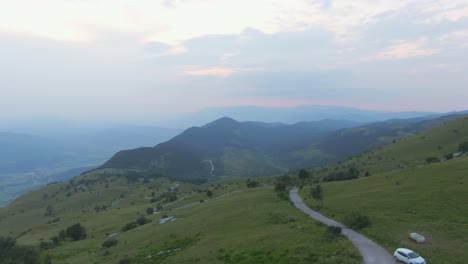 A-drone-shot-on-top-of-a-mountain--The-view-is-amazing-there-are-mountains-in-the-distance