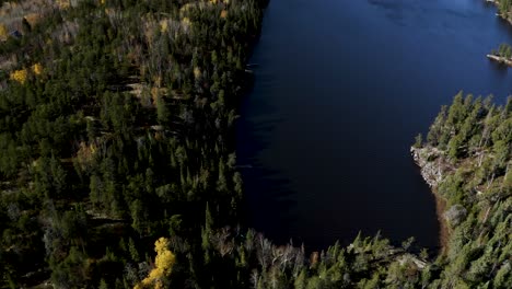 Aerial-dolly-forward-of-blue-lakes-nestled-in-a-boreal-forest-in-the-idyllic-Canadian-shield
