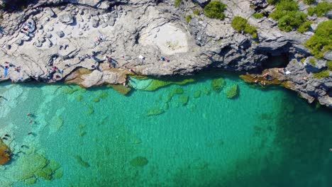 Top-Down-View-Tourists-Enjoying-the-Calm-Waters-of-the-Bruce-Peninsula,-Georgian-Bay