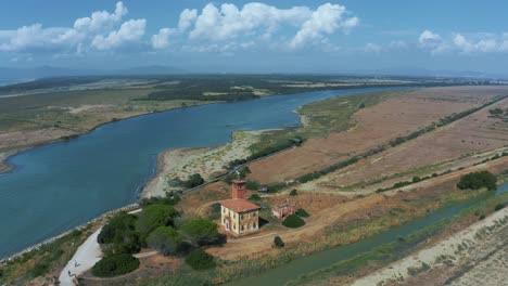 iconic beach and seaside with savannah seaside ocean coast at maremma national park in tuscany, italy with the ombrone river delta and blue water and cloud sky