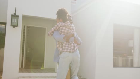 video of happy african american couple embracing in front of new house