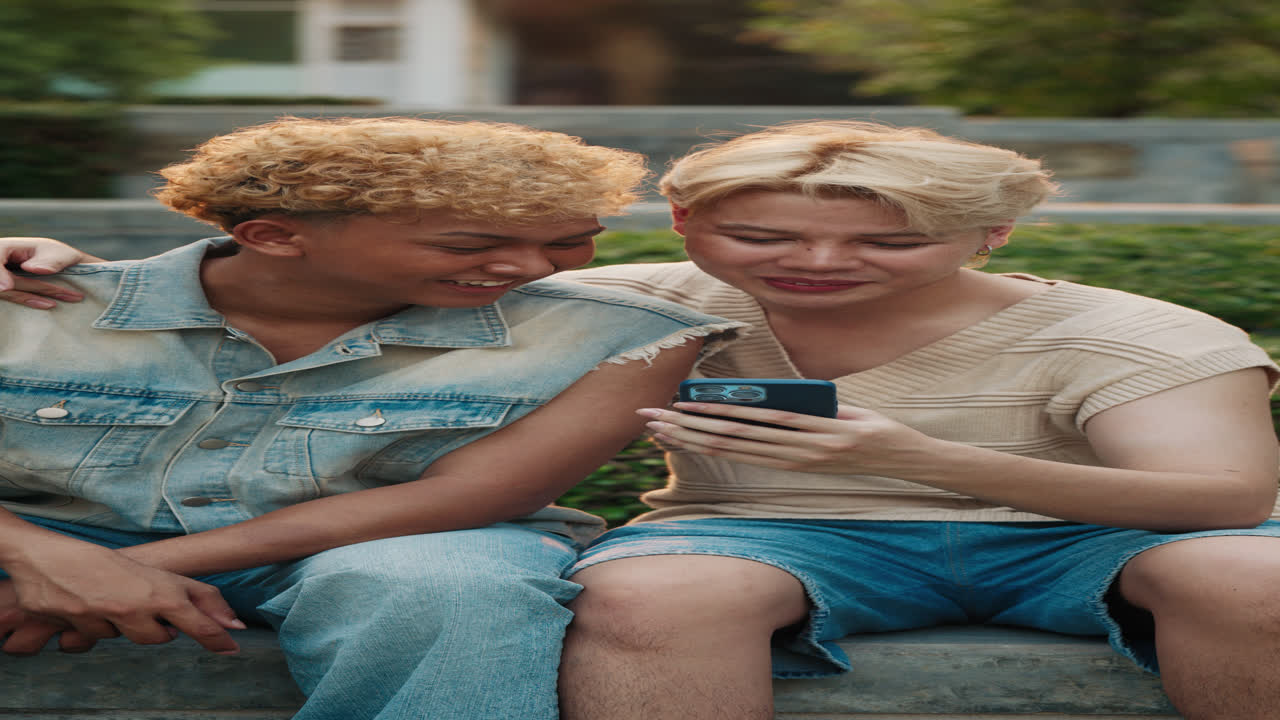 Two friends looking at a phone