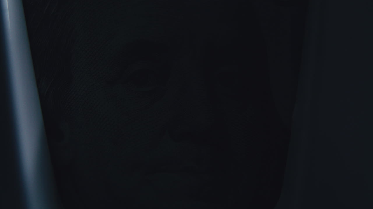 Close-up of a dollar bill partially obscured