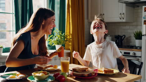 mother and son having breakfast together in the kitchen