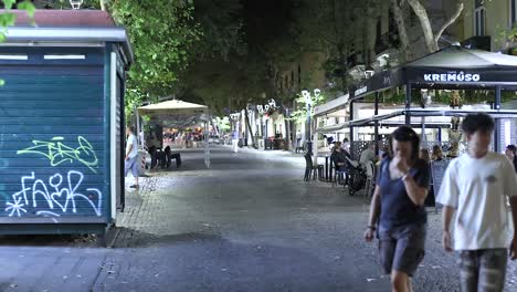 couple walking past a street restaurant