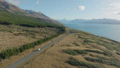 aerial alpine landscape of campervan driving through aoraki mount cook national park with stunning lake views in south island of new zealand aotearoa