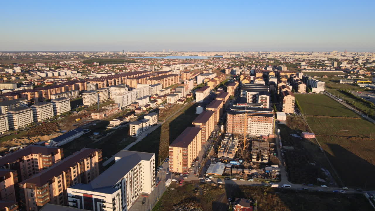 Aerial pan shot over many buildings under construction 4K