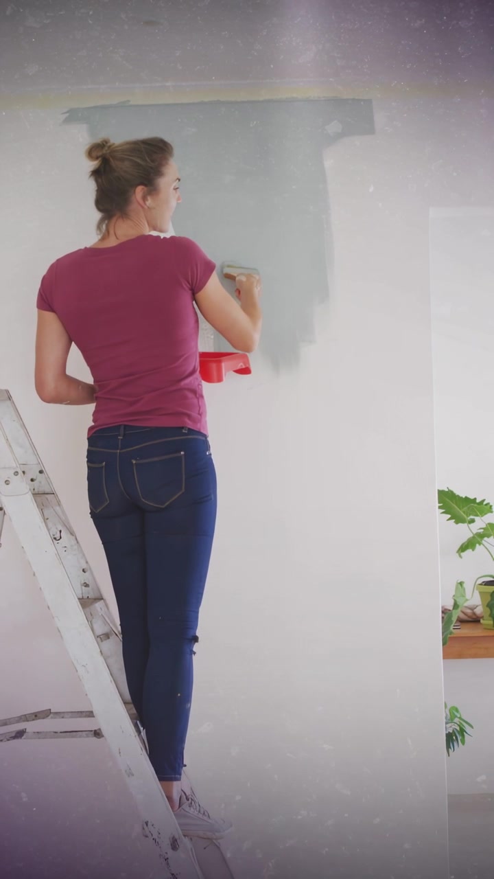 Vertical video: Woman on ladder painting wall with roller first stroke for DIY under dotted overlay