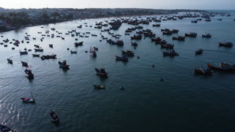 aerial view of mui ne fishing harbor vietnam asia, catamaran fishing net traditional boat, drone reveal scenic coastline of fisherman village