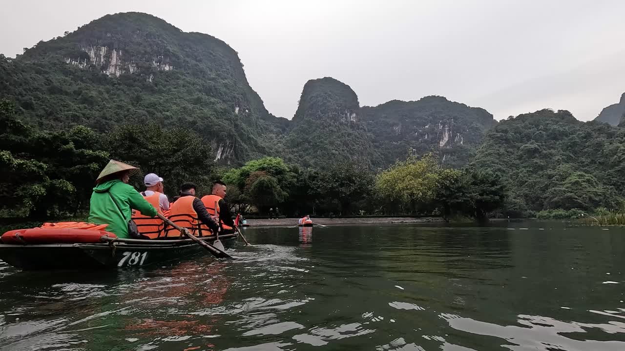 Tourists rowing boats in a serene landscape