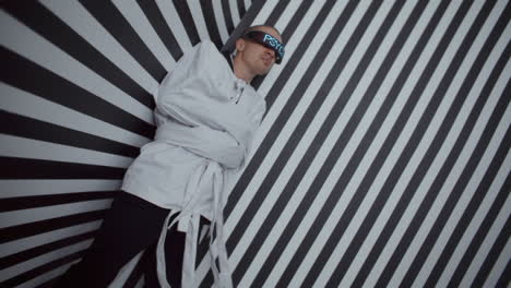 man in constraining clothing in a striped room