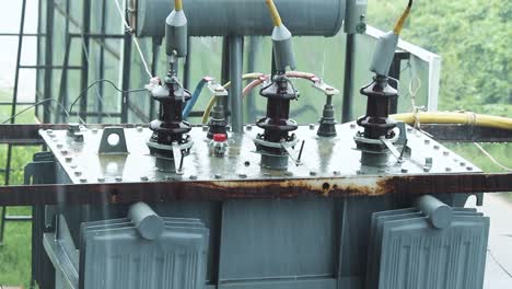raindrops fall on outdoor transformer during rain shower. moody, industrial and atmospheric clip ideal for weather, power or texture-focused projects