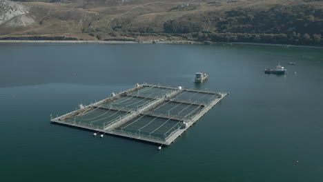 an aerial view of an aquaculture installation on loch eriboll in the scottish highlands on a sunny day