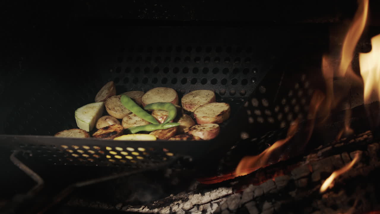 Potatoes with asparagus are fried over hot coals