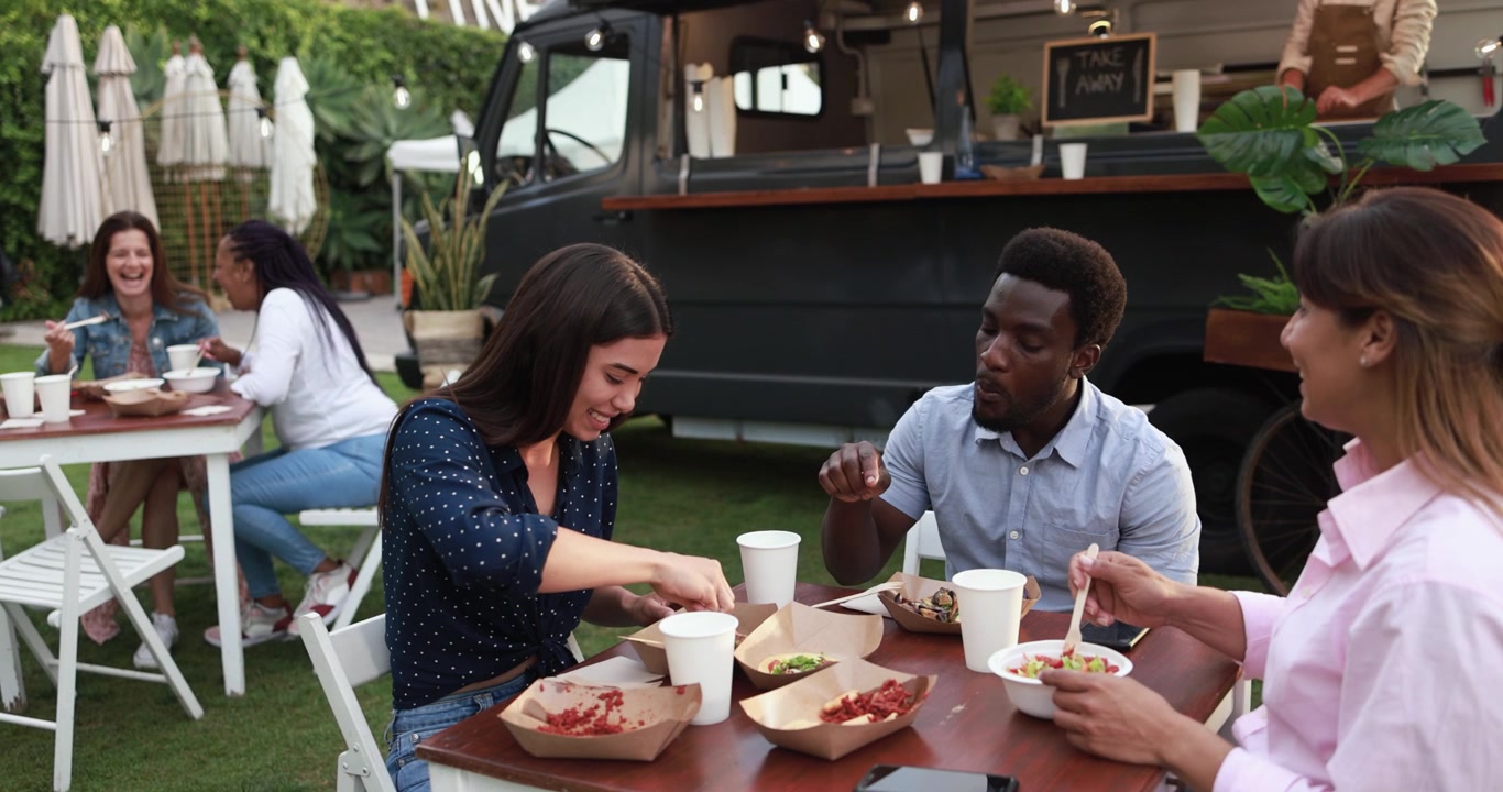 Diverse Friends Enjoying Food and Conversation at Outdoor Food Truck Event