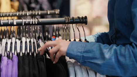 woman choosing clothes on the rack