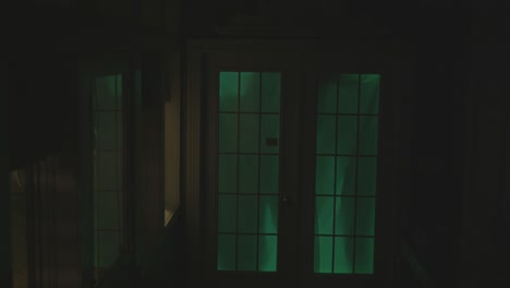 Dark-figures-are-moving-behind-a-glowing-door