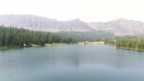 drone flies toward shoreline displaying the areas beauty