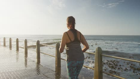 rear view of senior woman running on a promenade