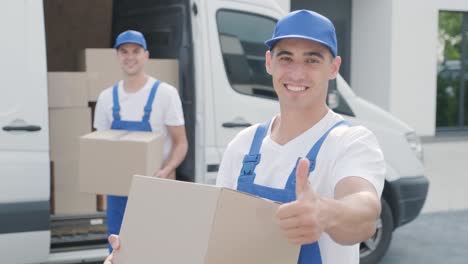 two young workers of removal company deliver boxes to a customer's home