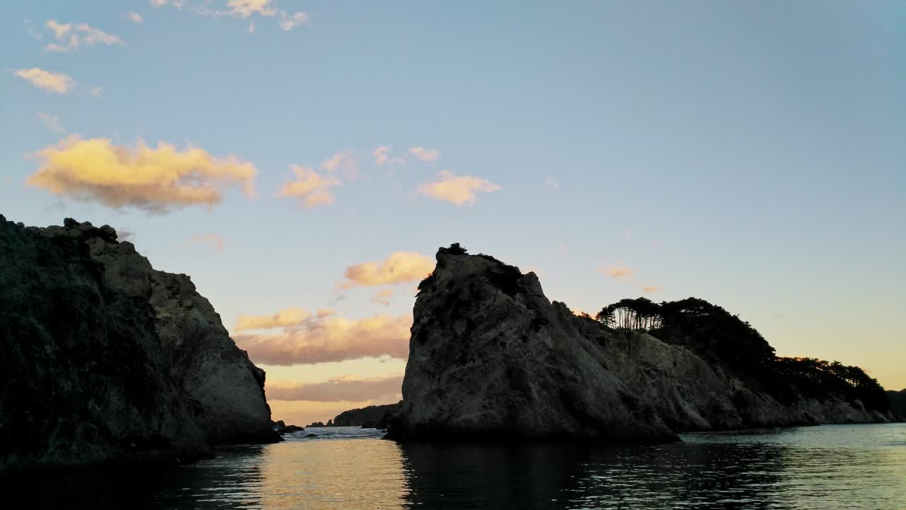 lapso de tiempo de la puesta de sol en la formación rocosa costera de la playa de jodogahama, japón