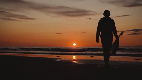 Man-running-with-guitar-in-back-sand-beach-at-sunset-35