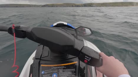 pov shot of a jet ski rider starting his engine with jet skiers taking off