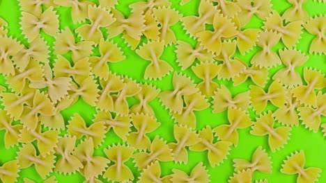 stop motion animated pasta farfalle on green screen background. top view close up food backdrop.
