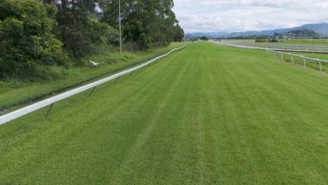 drone flyover of lush green race track