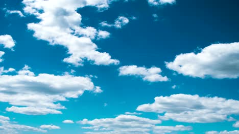 time lapse clip of white fluffy clouds over blue sky 4k