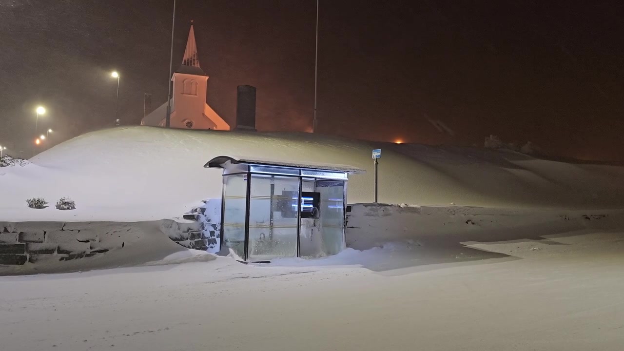 Footage of a bus stop during snow storm