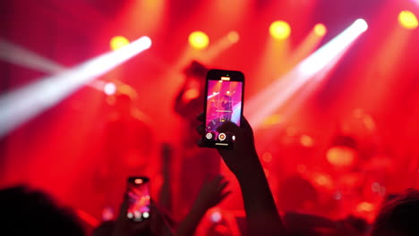 audience capturing live music performance with smartphones in vibrant concert atmosphere